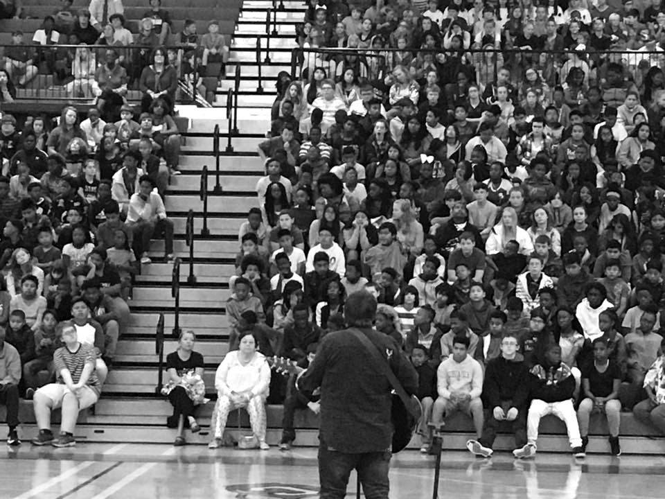 Students in the bleachers at a school assembly